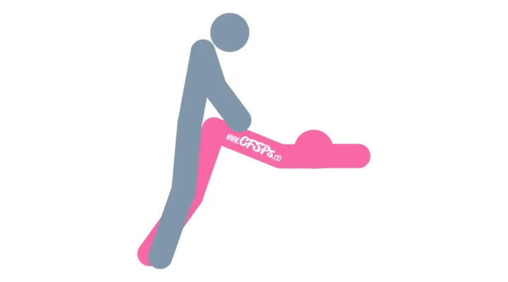 This stick figure image depicts a man and woman having sex in the Layover sex position. The woman is standing at the side of the sofa, lying over the armrest with her upper body resting on the seat cushion. The man is standing behind her with his hands holding her butt.